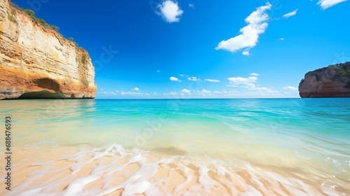 Beach and sands next to a cliff with blue sky and clouds