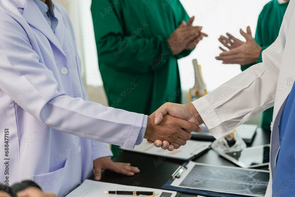 Researchers with medical experience shaking hands after successful medical conference, dedicated to health care doctors, medical nurses after successful work in hospitals. Researchers with medical experience shaking hands after successful medical conference, dedicated to health care doctors, medical nurses after successful work in hospitals.