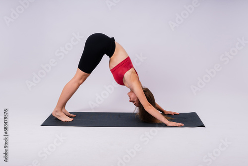 Beautiful female in yoga studio. A woman doing a yoga. Lady in a top.