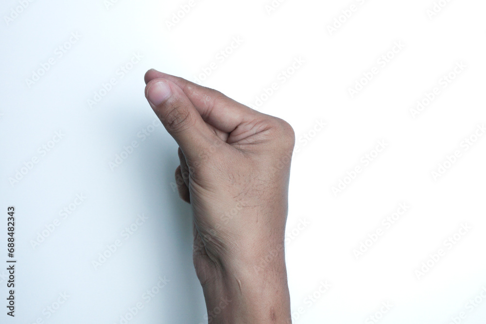 Man holding something in hand on white background, closeup Man holding something in hand on white background, closeup