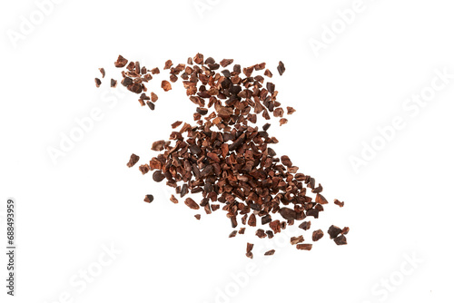 Cocoa nibs scattered on white background. Design element. Crunchy pieces of peeled, crushed and lightly roasted cocoa beans with pleasant chocolate bitterness. Sugar-free product photo