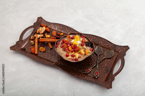 Traditional Turkish Dessert Ashure on metal serving dish. Sweet delicious pudding also called as Noah's pudding or Noah's Dessert. Alternative names Ashura, anusabur, ashoure photo