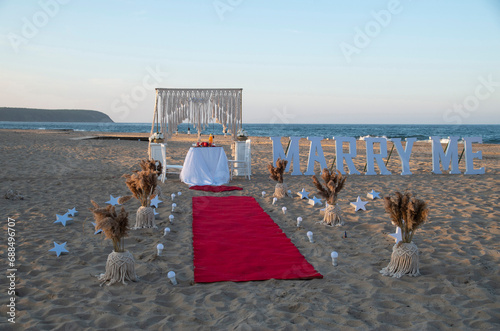 Fototapeta Naklejka Na Ścianę i Meble -  Beach marriage proposal on romantic dinner at sunset