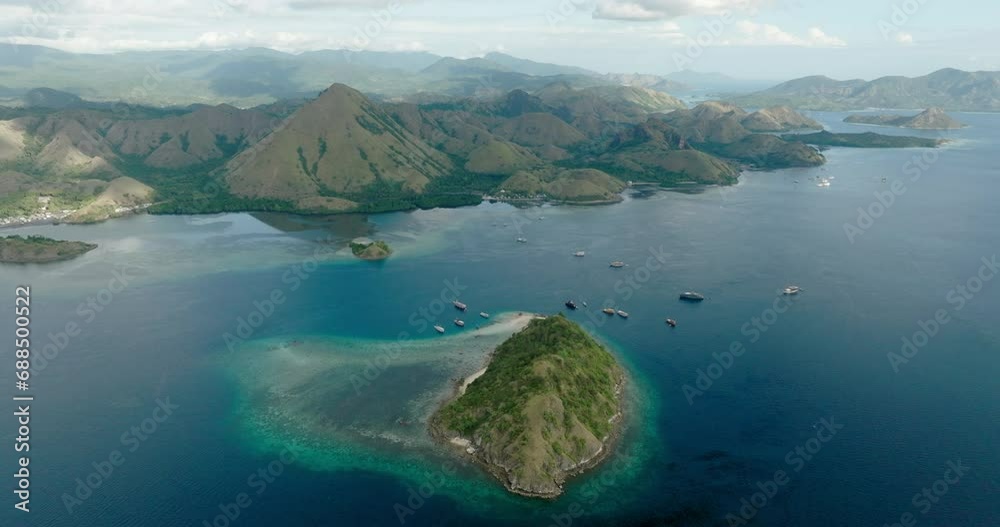 Aerial Scenic View Of Komodo Mountains, Drone Flying Forward Over Tranquil Sea Aerial Scenic View Of Komodo Mountains, Drone Flying Forward Over Tranquil Sea