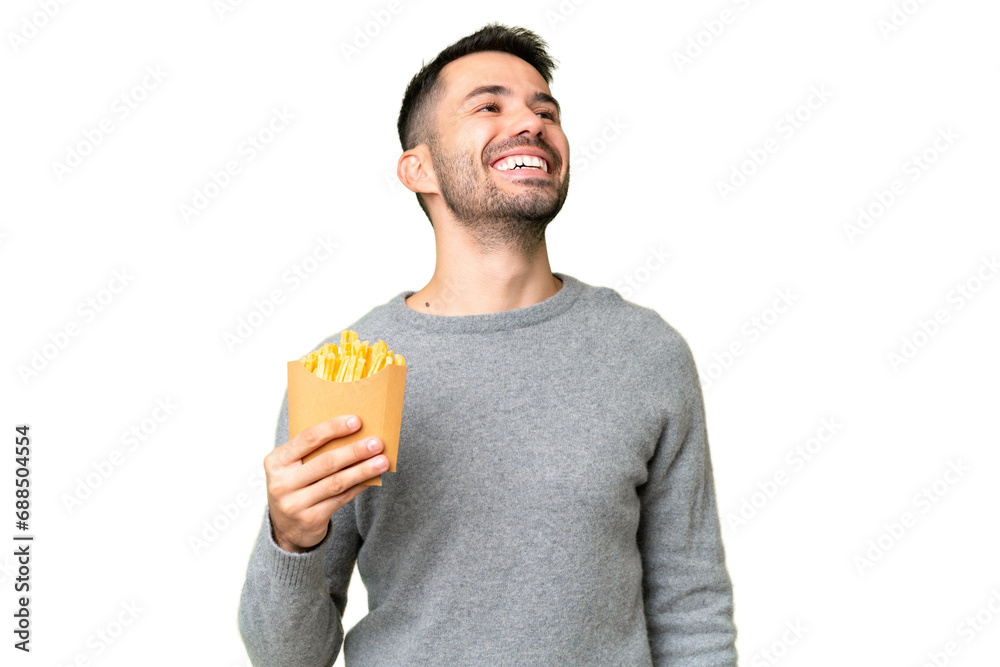 Young caucasian man holding fried chips over isolated chroma key background laughing Young caucasian man holding fried chips over isolated chroma key background laughing