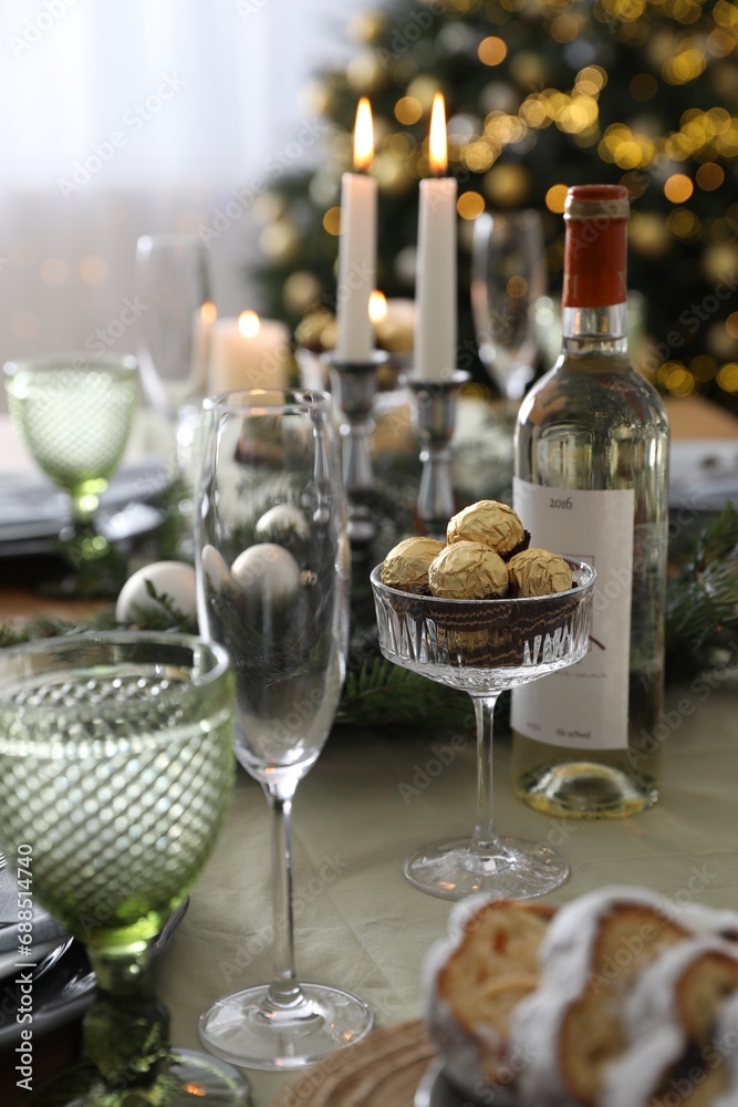 Christmas table setting with festive decor and glassware indoors