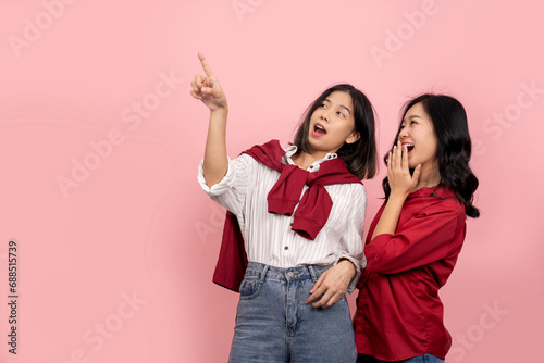 A long-haired woman in a red shirt and jeans looked surprised and covered her mouth with her hand. Excited Asian girl in white shirt pointing at text on pink background.