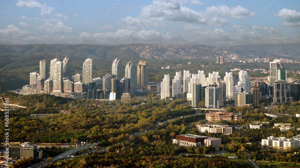 Obraz premium Aerial view to a modern city with skyscrapers, dormitory area and parks.