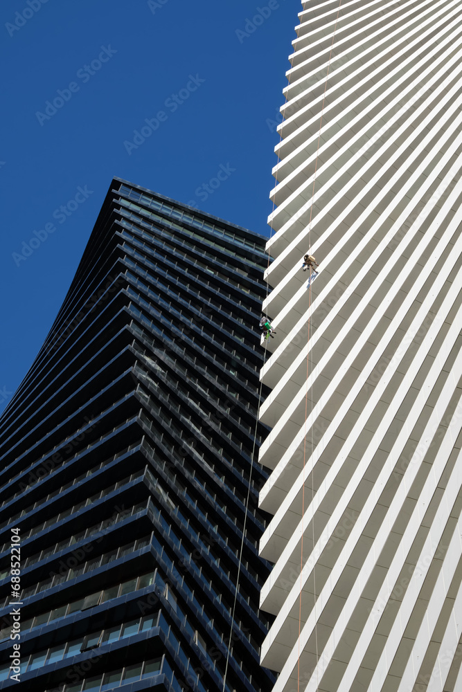 Vertical image a cleaning company performs work on a skyscraper. Vertical image a cleaning company performs work on a skyscraper.