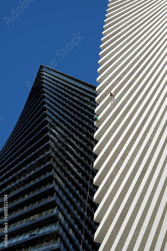 Vertical image a cleaning company performs work on a skyscraper.