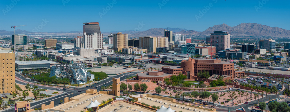 Aerial cityscape view featuring a blend of modern skyscrapers and traditional buildings, with a circular park complex in Las Vegas.