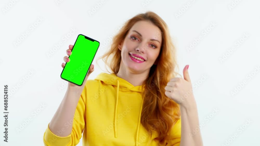 Advertising, green screen, chroma key, Yes gesture and woman with phone for product placement, branding and mobile app marketing. Smiling lady female with mobile smartphone, approval emotion on white Advertising, green screen, chroma key, Yes gesture and woman with phone for product placement, branding and mobile app marketing. Smiling lady female with mobile smartphone, approval emotion on white