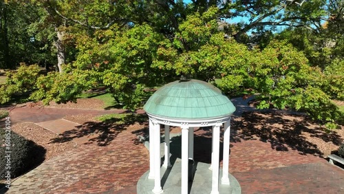 Famous Old Well, a historical landmark inside University of North Carolina Chapel Hill campus. Aerial rising shot. photo