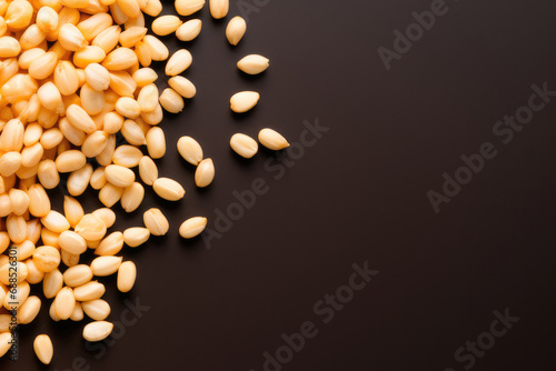 Grains of wheat on a black table, top view, copy