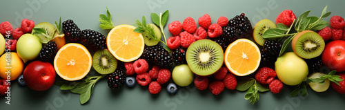 Banner from various fruits on green background  top view  creative flat layout. Concept of healthy eating  food background.