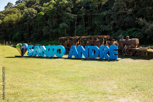 Santo André city sign in Paranapiacaba with an old train in the background photo