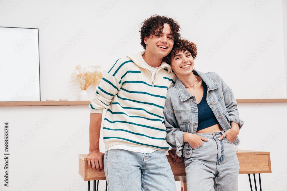 Smiling beautiful woman and her handsome boyfriend with curls hairstyle. Happy cheerful family having tender moments in white interior in studio.Pure cheerful models hugging. Embracing each other Smiling beautiful woman and her handsome boyfriend with curls hairstyle. Happy cheerful family having tender moments in white interior in studio.Pure cheerful models hugging. Embracing each other
