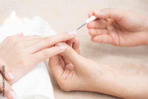 Woman receive care service by professional Beautician Manicure at spa centre. Nail beauty salon use nail file for Glazing treatment. manicurist make nail customer to beautiful. body care spa treatment