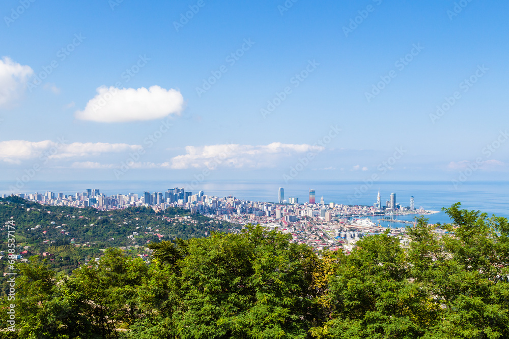 travel to Georgia - green trees and view of Batumi city on background from Sameba on sunny autumn day