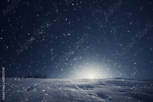 Winter background - sparkling falling snow against a dark blue sky and white snowdrifts. © Dennis