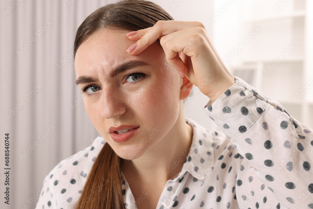 Fototapeta premium Young woman with skin problem at home