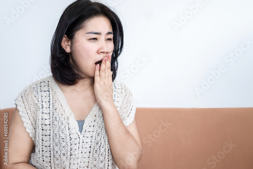 lack of sleep ,sleep deprivation concept with Asian woman yawning , sleepy and fatigue during daytime photo