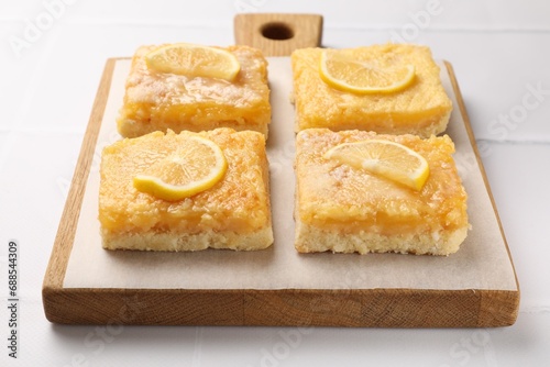 Tasty lemon bars on white table, closeup