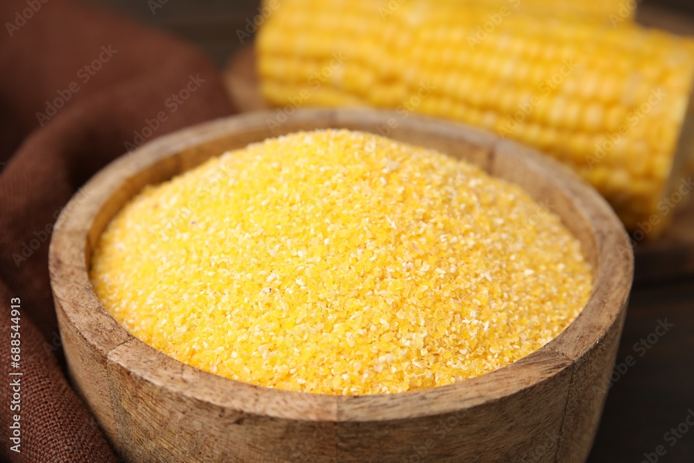 Raw cornmeal in bowl on table, closeup Raw cornmeal in bowl on table, closeup