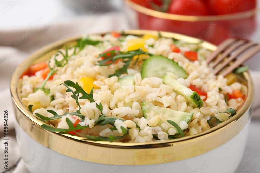 Cooked bulgur with vegetables in bowl, closeup