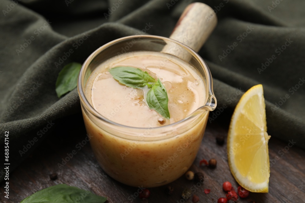 Delicious turkey gravy, basil, peppercorns and lemon on wooden table, closeup Delicious turkey gravy, basil, peppercorns and lemon on wooden table, closeup
