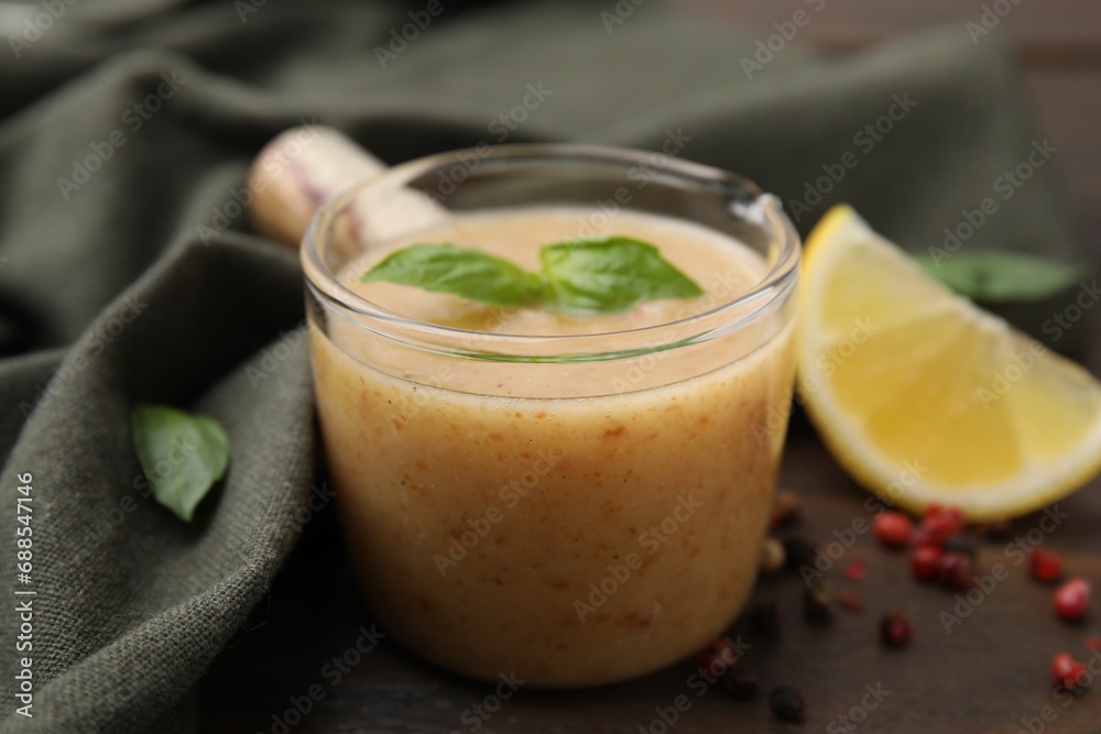 Delicious turkey gravy, basil, peppercorns and lemon on table, closeup Delicious turkey gravy, basil, peppercorns and lemon on table, closeup