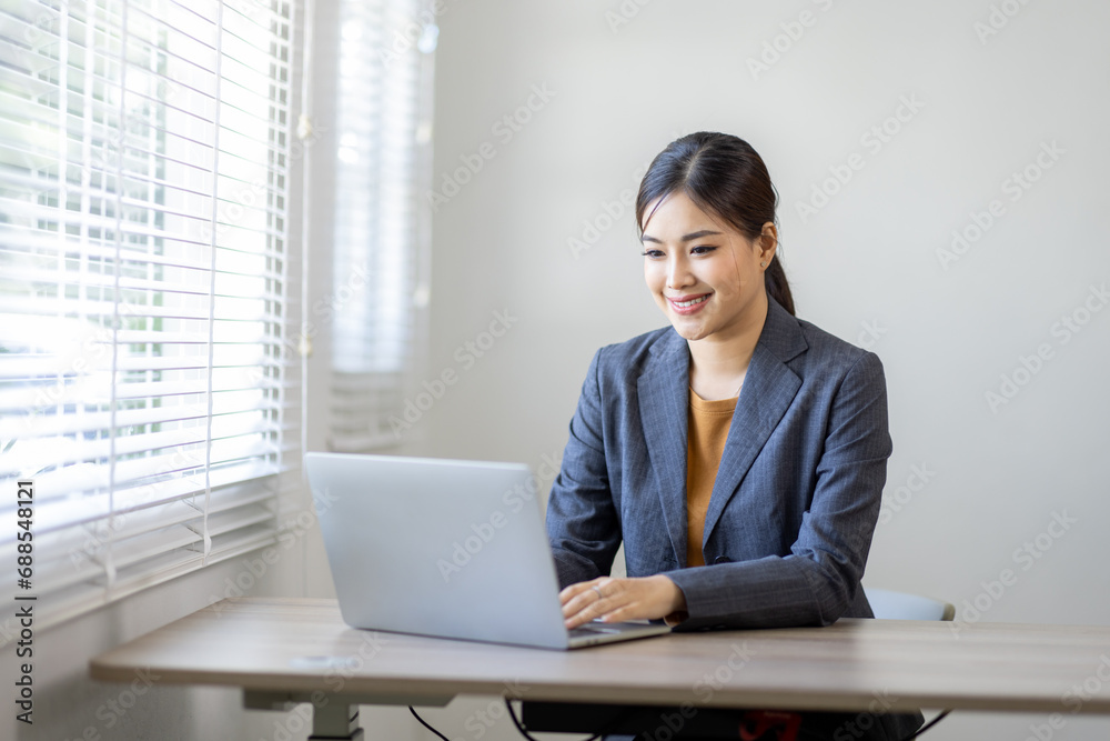 Asian Business woman work on laptop for doing math finance on an office desk, tax, report, accounting, statistics, and analytical research concept
Asian Business woman work on laptop for doing math finance on an office desk, tax, report, accounting, statistics, and analytical research concept