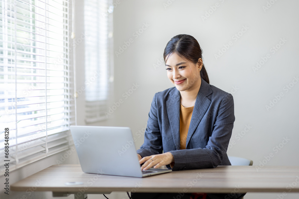 Asian Business woman work on laptop for doing math finance on an office desk, tax, report, accounting, statistics, and analytical research concept
Asian Business woman work on laptop for doing math finance on an office desk, tax, report, accounting, statistics, and analytical research concept