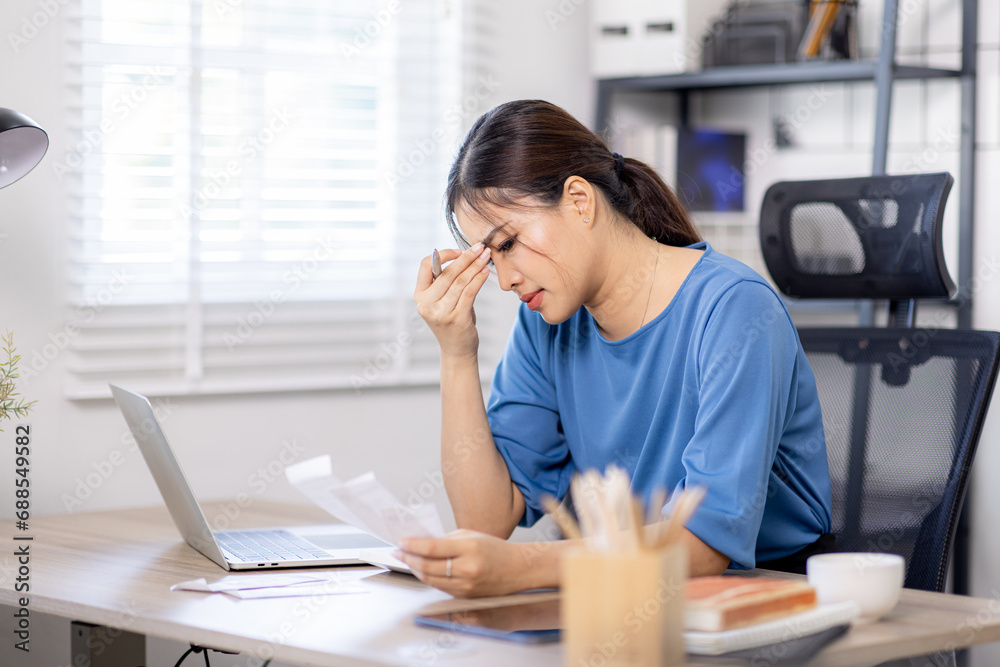 Frustrated desperate millennial woman checking bills for payments, holding receipts, getting upset about overspending, too high mortgage, insurance fees. Homeowner analyzing costs, expenses, budget Frustrated desperate millennial woman checking bills for payments, holding receipts, getting upset about overspending, too high mortgage, insurance fees. Homeowner analyzing costs, expenses, budget