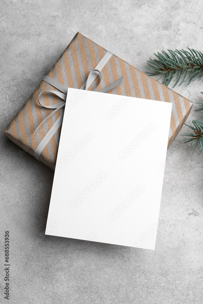 Blank Christmas or New Year card mockup with gift box, paper greeting card with copy space Blank Christmas or New Year card mockup with gift box, paper greeting card with copy space