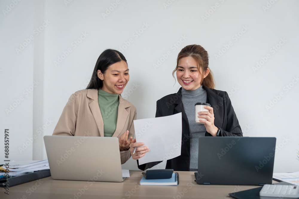 Business team two colleague are sitting at the meeting room and discuss chart and statistics Business team two colleague are sitting at the meeting room and discuss chart and statistics