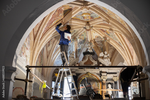 Equip of Expertise Restorers On a Working Platform Under Church Ceiling Restoring Beautiful Antique Gothic Fresco