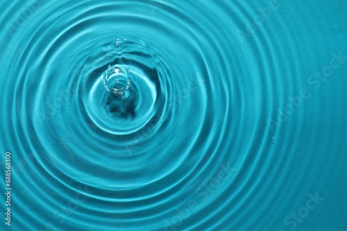 Rippled surface of clear water on light blue background  top view