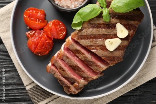 Delicious grilled beef steak with tomatoes and spices table, top view