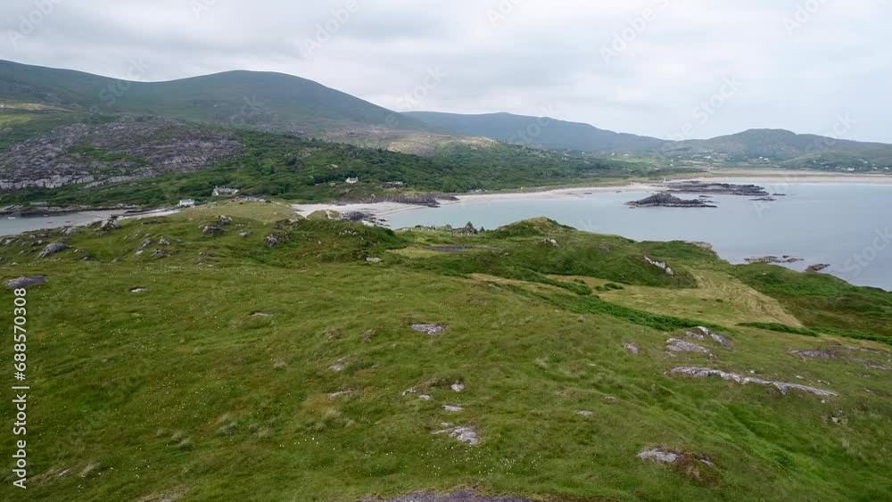 A low-flying drone shot of an old and historic cemetery on a small and isolated peninsula in Ireland. A low-flying drone shot of an old and historic cemetery on a small and isolated peninsula in Ireland.