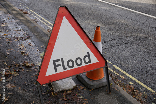 Flood warning sign on road after heavy rainfall. warning sign for motorists of ahead flooded road surface 