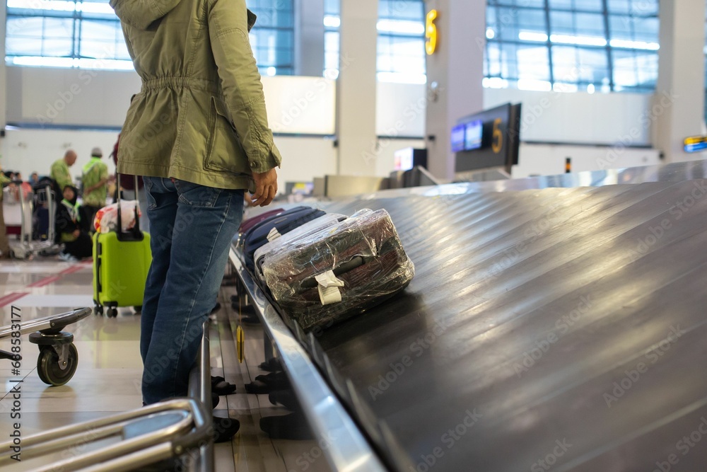Luggage belt with suitcases being delivered to the passengers at the arrival terminal Luggage belt with suitcases being delivered to the passengers at the arrival terminal