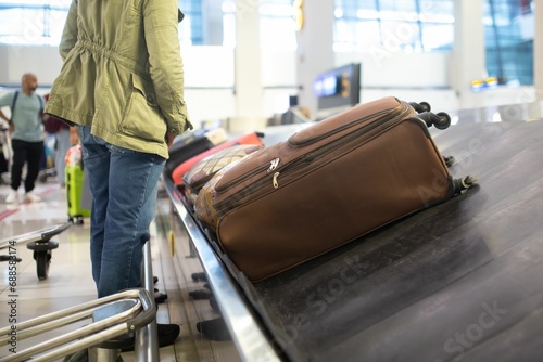 Luggage belt with suitcases being delivered to the passengers at the arrival terminal