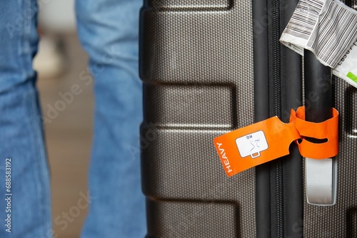 Closeup of a big suitcase tagged as Heavy photo