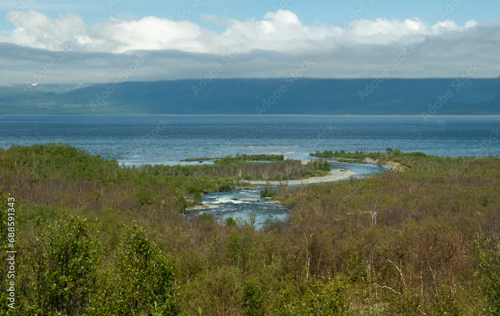 Watercourse and lake Tornetrask at Abisko National Park in Lapland, Sweden.