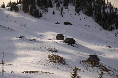 old huts in mountains. Winter mountain range in Carpathian Mountain, Ukraine. Winter trekking
