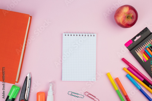 Back to school. Stationery on a pink table. Office desk with copy space. Flat lay.