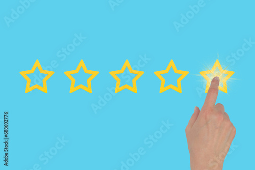 A woman's hand leaves a rating of five stars out of five on a blue background. The concept of evaluating something.