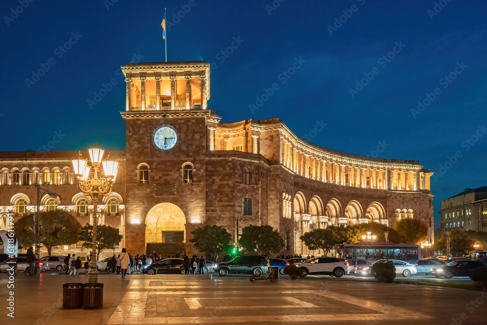Architecture of Armenia. Sights of Yerevan. Stone building with clock and flag. Republic square in Yerevan. Streets of capital of Armenia. Architecture of Yerevan. Vacations in Armenia