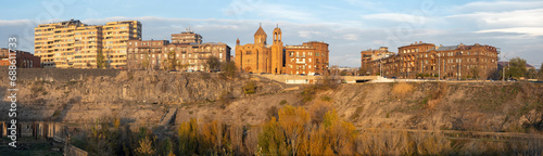 Panorama of Armenia. Cityscape Yerevan. Bank of Hrazdan river. View of city with old church. Yerevan cityscape. Panorama of Armenia with blue sky. City buildings on rocky river bank. Tour in Armenia